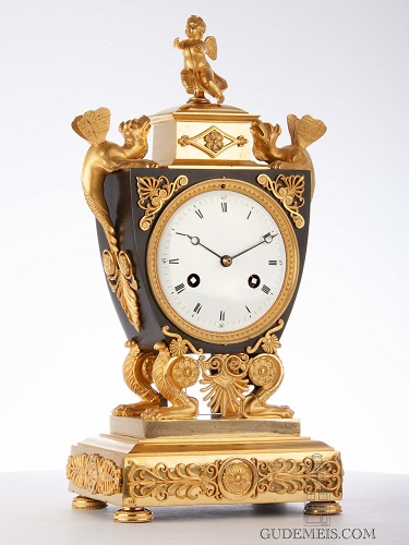 A French Empire ormolu and bronze urn striking mantel clock, circa 1800.